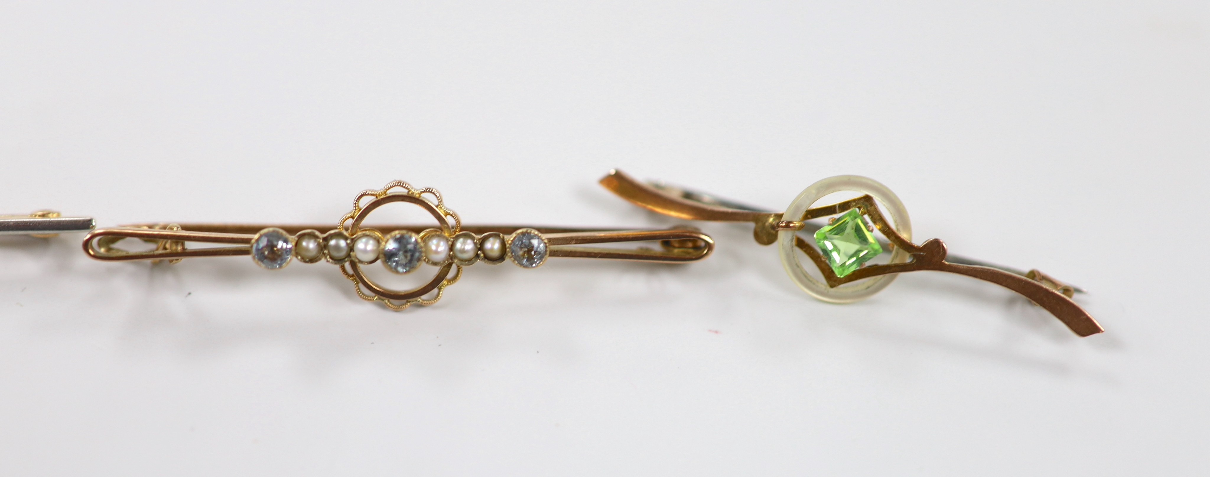 A Victorian 15ct, diamond and seed pearl cluster set bar brooch, 59mm, gross 4 grams and three other early 20th century gem set bar brooches including two 9ct, gross weight 8.7 grams.